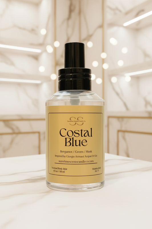 A bottle of Costal Blue Bergamot / Green / Musk facial mist with a black spray top and a beige label, set on a white marble surface with a softly blurred bathroom background.
